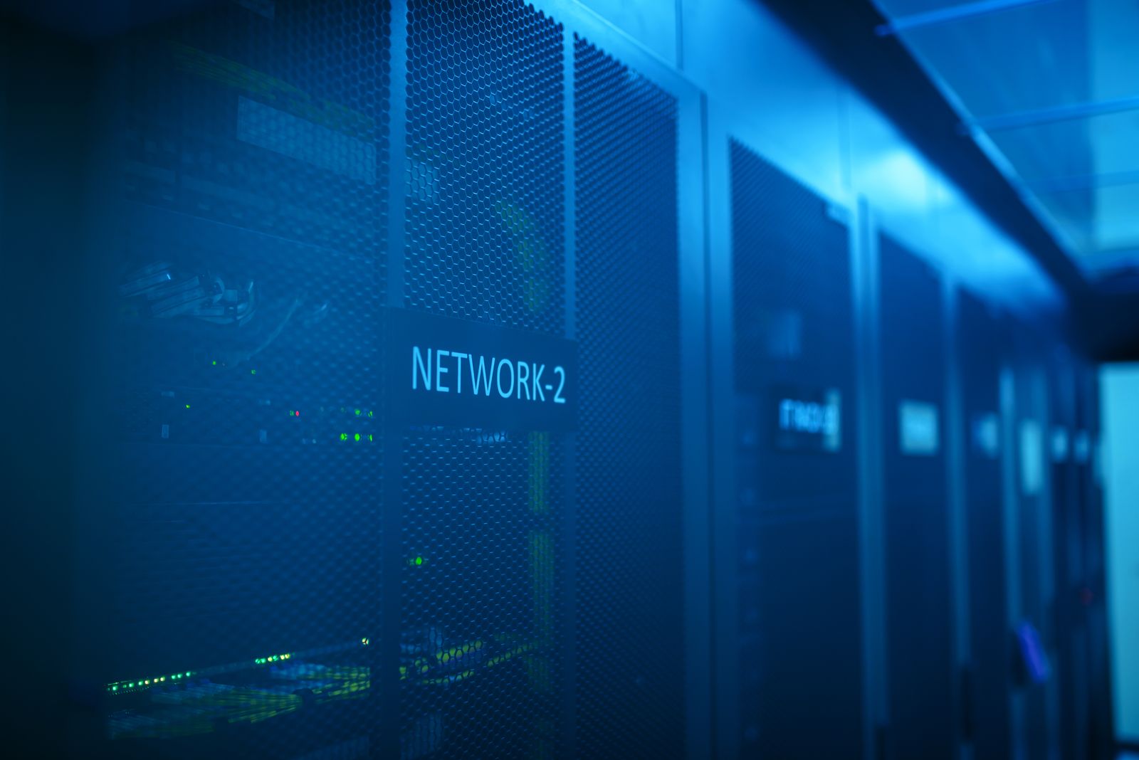 Blue-lit AI server room with network racks