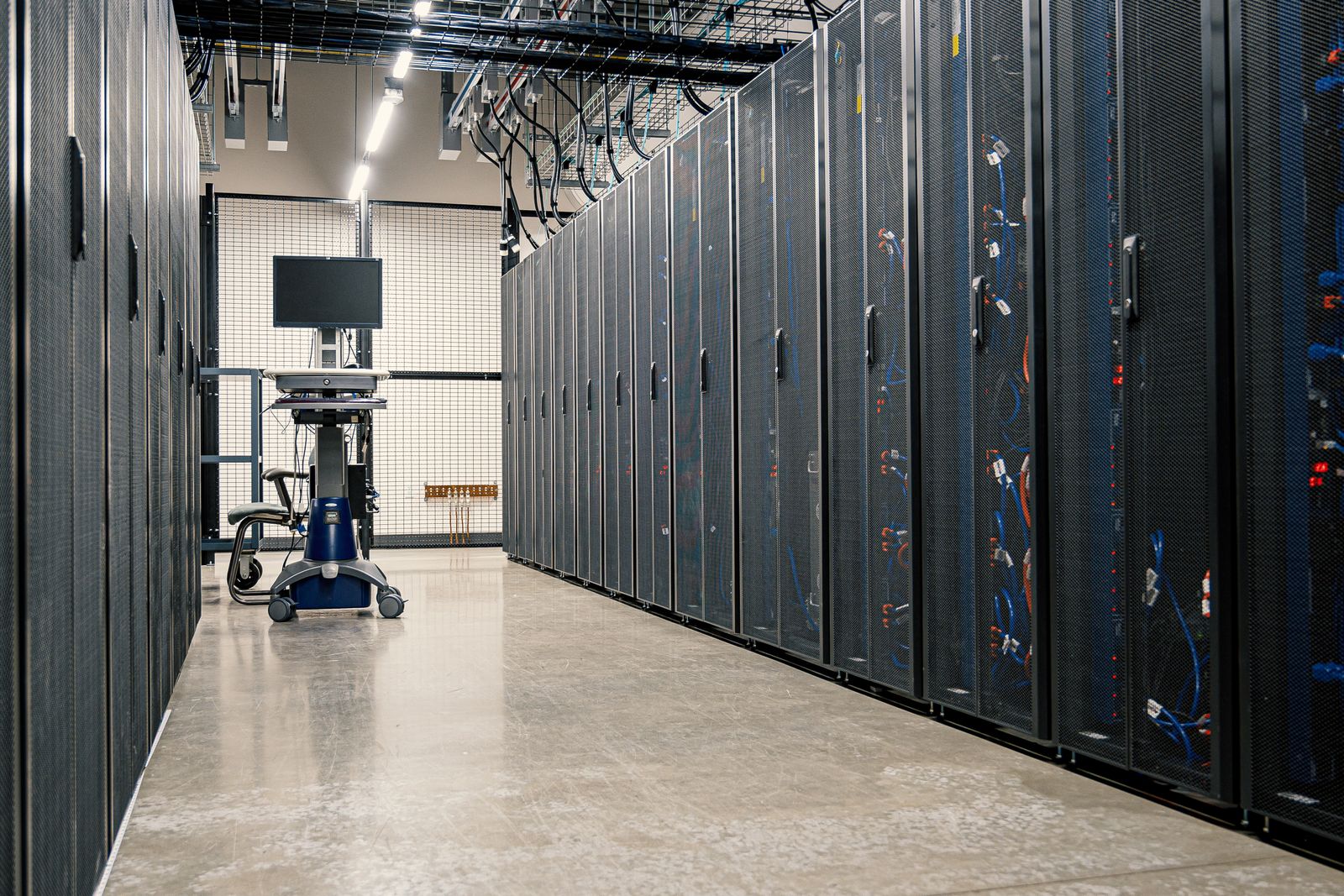 Row of server racks in a data center corridor